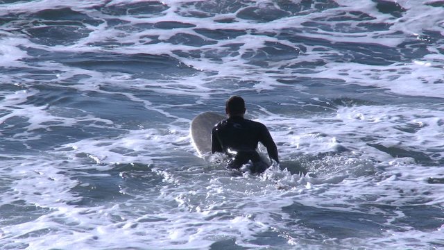 Surfers waiting for waves at Pismo Beach, California.