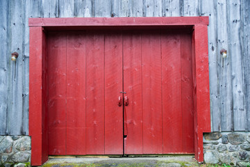 Obraz na płótnie Canvas Red Door on a Wooden Barn