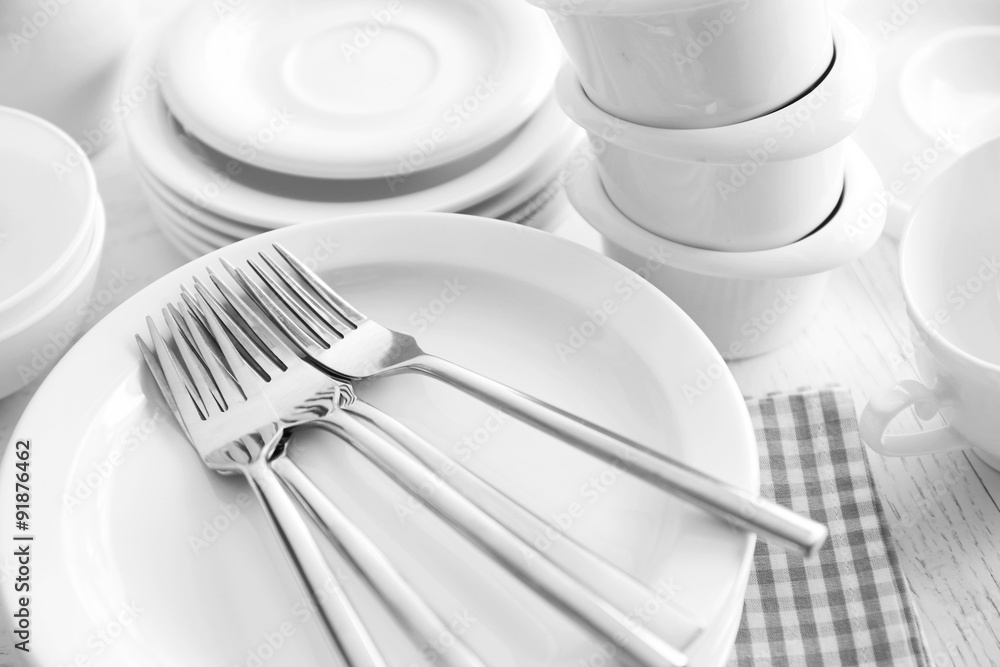 Poster Set of white ceramics dishes on wooden table, closeup