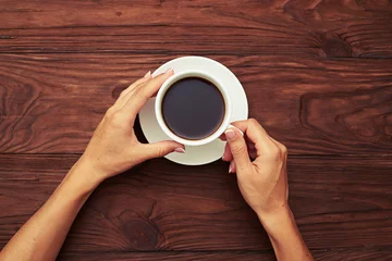 Fotobehang womans hands holding cup of coffee © ArtFamily