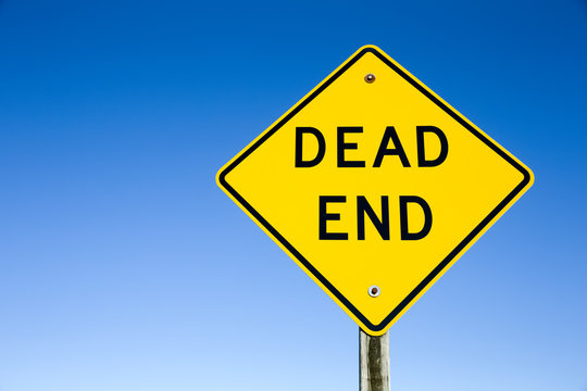 Dead End Sign Against Blue Sky