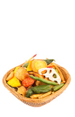 Mix vegetable chips in a wicker bowl over white background