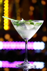Glass of cocktail on bar background