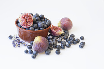 Fresh blueberries and figs in pottery