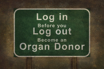 Log in before you log out become an organ donor roadside sign, with ominous background
