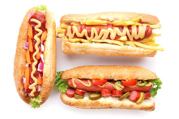 Three fresh hot dogs isolated on white
