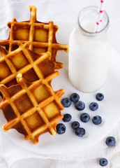 Belgian waffles with milk and fresh berries.selective focus