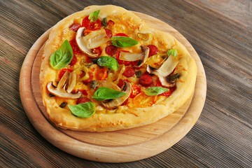 Heart shaped pizza on wooden background