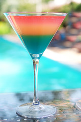 Cocktails on swimming pool background
