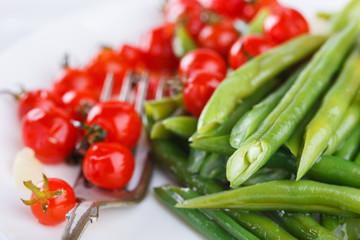 Peppers green beans with cherry tomatoes. Salad on a white background.