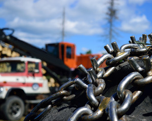 Naklejka premium Skidder Tire Chains and Log Loader