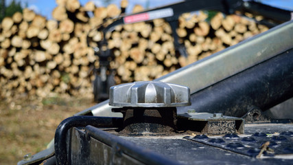 Diesel Fuel Cap on Log Skidder with Loader in Background