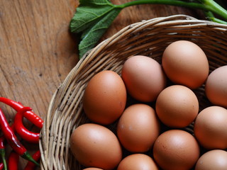 basket eggs and vegetable on vintage wooden background