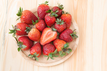 Slice fresh strawberry on wood background