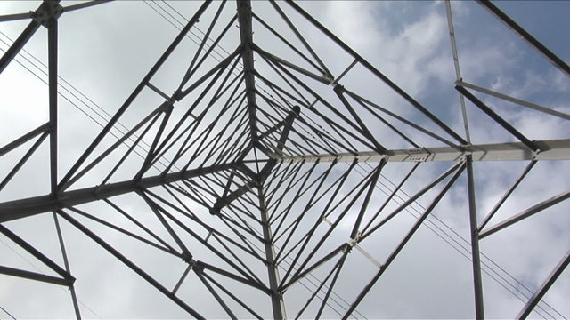 Wires stretch to either side of a utility tower.