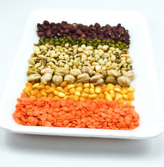 seeds, grains on a white plate in a white background close up