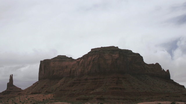 Clouds pass over a mesa in the desert