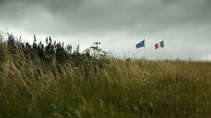 National flags at D Day Beach at Arromanches, France - Powered by Adobe