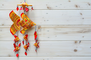 Handmade carp  made of palm leaf on wooden background
