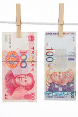 China and Malaysia Currency on Clothesline