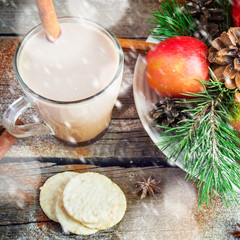 Cocoa on a background of Christmas decorations. Snowing