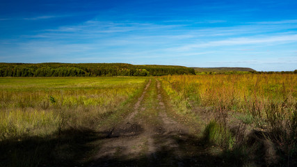 Country road on background of the blue sky, Autumn, Russia