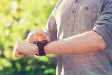 Man checking his smartwatch outside