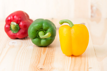 Yellow sweet peper on wooden background