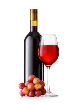 Glass and bottle of red wine with grapes
