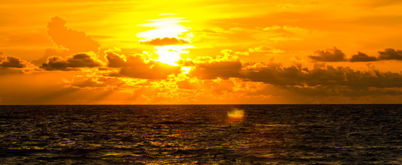 Sunset over the sea,Sun background with clouds and flare