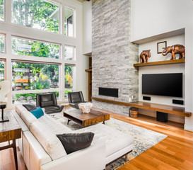 Beautiful living room with hardwood floors and fireplace in new luxury home
