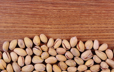 Pistachio nuts on wooden table, healthy eating