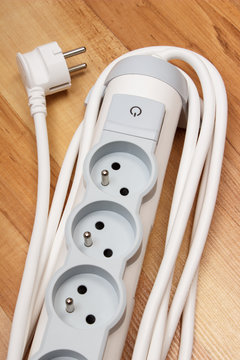 Electrical power strip with switch on-off on wooden floor