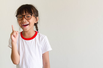 Asian girl kid is thinking for something and have a good idea