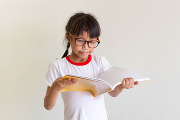 Asian girl kid is funny to read a book