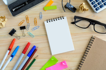 Blank notebook with office supply on desk