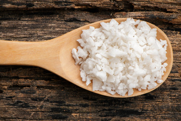 Salt on wooden spoon put on table