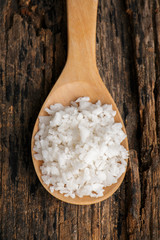 Salt on wooden spoon put on table