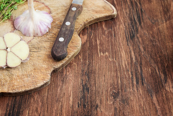 Garlic on an old cutting board. Cooking or spicy food concept.