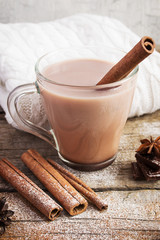 Hot cocoa with cinnamon sticks  on white background