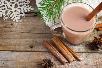 Fototapeta na wymiar A cup of cocoa with cinnamon on a wooden background.