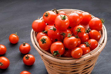 pile of cherry tomatoes in a rattan basket