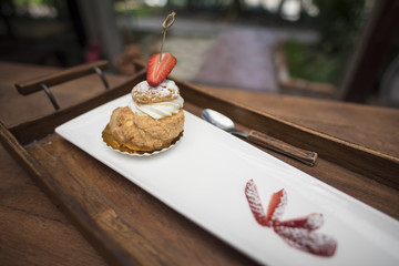 fresh strawberry Choux Cream on wooden tray.