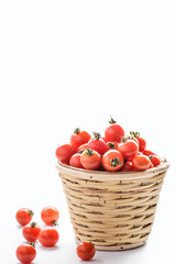 pile of cherry tomatoes in a rattan basket