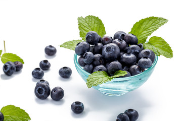 blueberries and mint leaves in a glass bowl