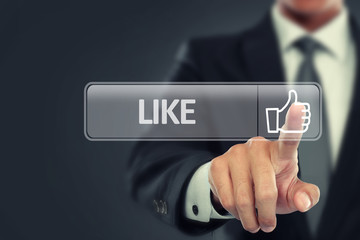 Businessman push to like button on virtual screen