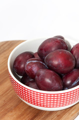 Fresh violet plums in the bowl