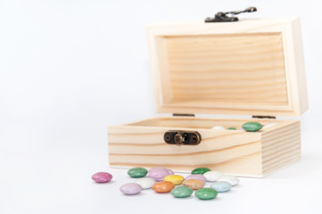 Wooden chest gift box with colorful round chocolates