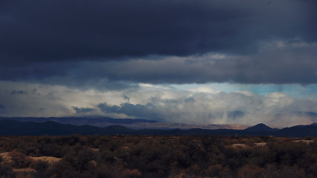 Time Lapse 2048: Time lapse storm clouds travel over desert and mountains.