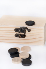 Wooden black and white chips in wooden chest